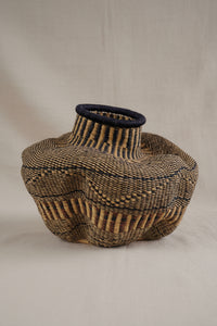 Woven basket with a textured design on a white background