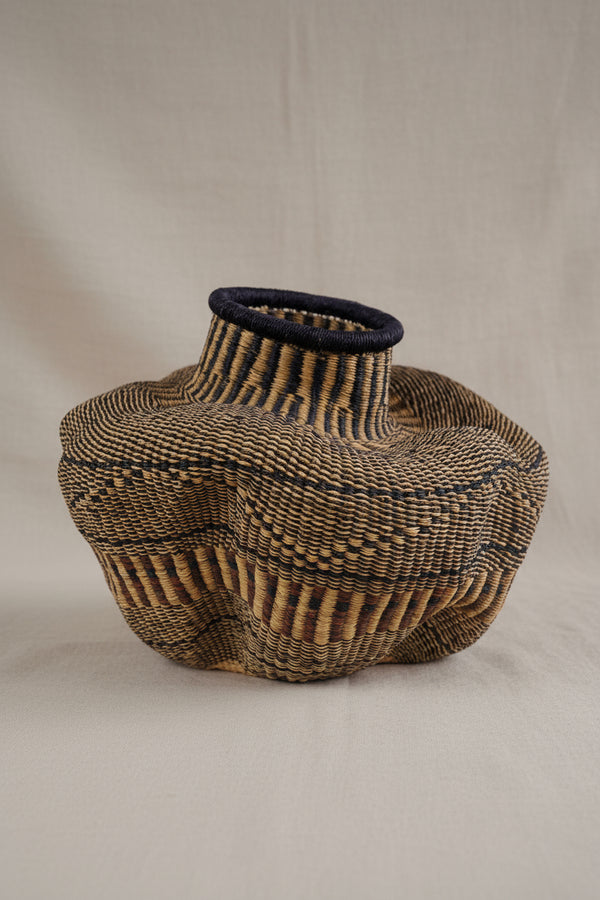 Woven basket with a textured design on a white background