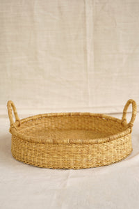 Woven basket with handles on a beige background