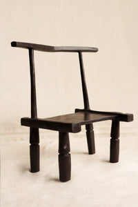 Wooden chair with a minimalist design on a beige background