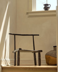 Wooden chair on a windowsill with soft lighting
