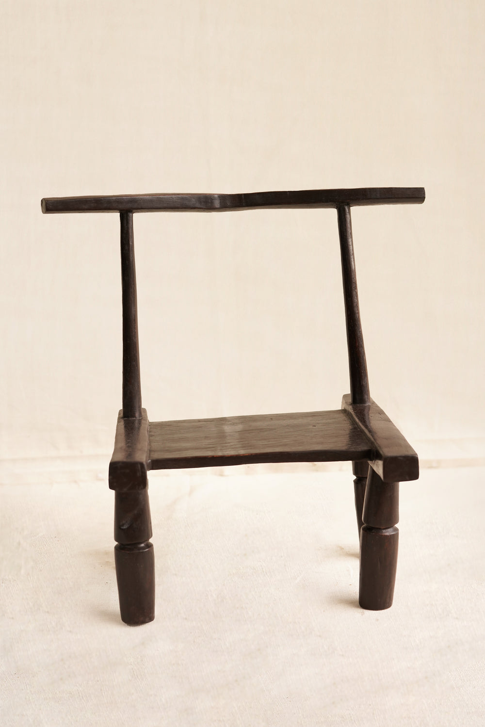 Black wooden chair on a beige background