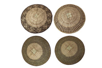 Four woven baskets with geometric patterns on a white background