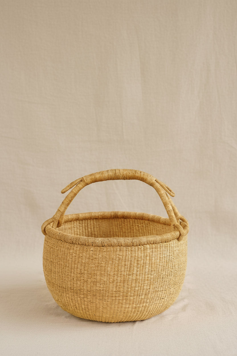 Woven basket with handles on a beige background