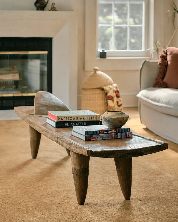 Wooden coffee table with books in a living room setting