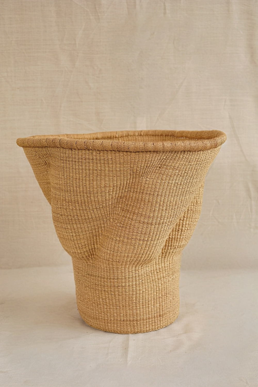 Woven basket on a beige background